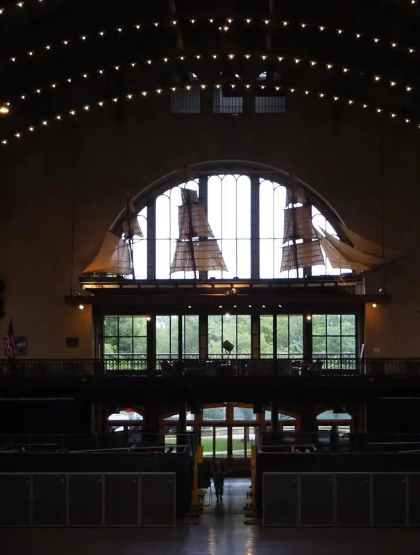 Grand hall with an arched window and strings of lights