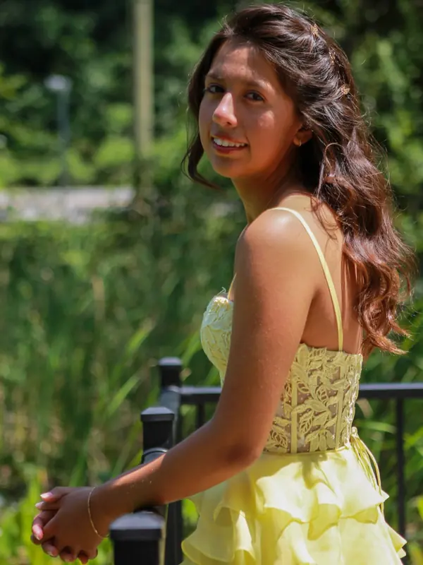 Quinceañera looking back over her shoulder with a smile