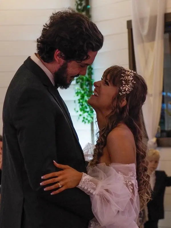 Bride laughing up at the groom during their first dance